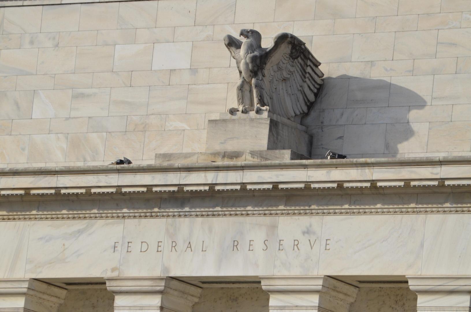 Federal Reserve building with crypto symbols overlay, illustrating Federal Reserve crypto policy discussions.