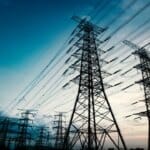 Power grid infrastructure showing high voltage transmission lines and electrical substations