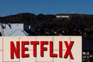 Netflix corporate logo with a financial growth chart representing the netflix picks investor leadership change