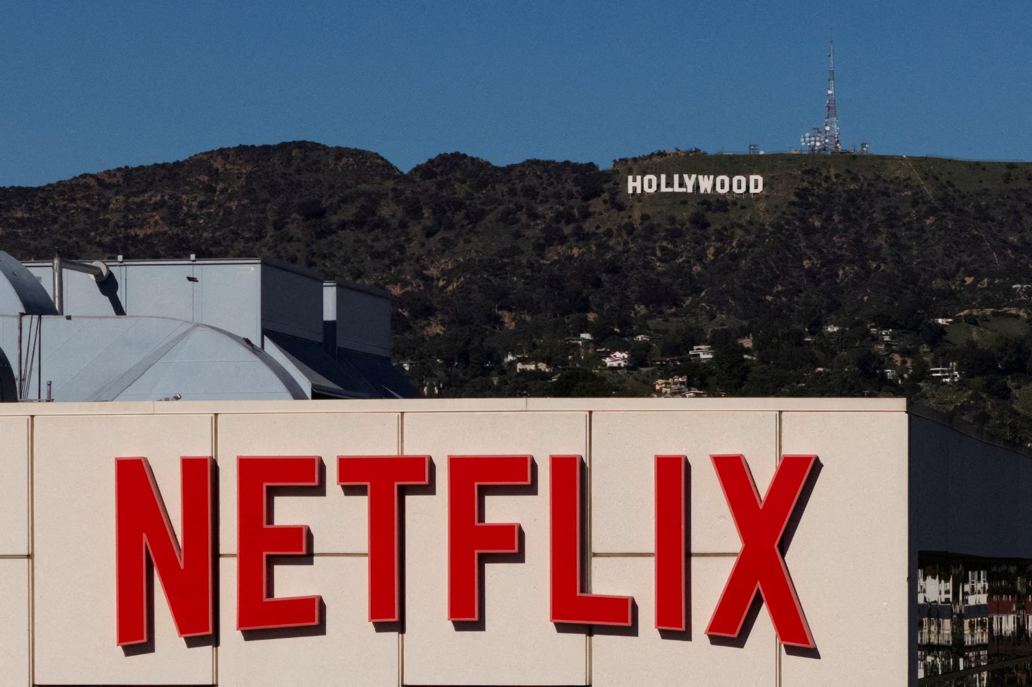 Netflix corporate logo with a financial growth chart representing the netflix picks investor leadership change