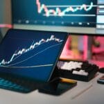 Professional trader analyzing live markets: bitcoin charts on multiple monitors