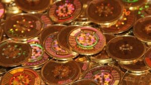 A close-up of a rare physical bitcoin with a tamper-evident hologram