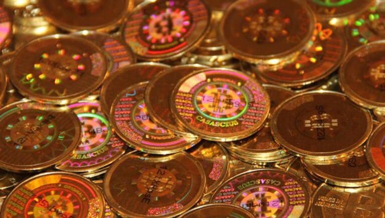 A close-up of a rare physical bitcoin with a tamper-evident hologram