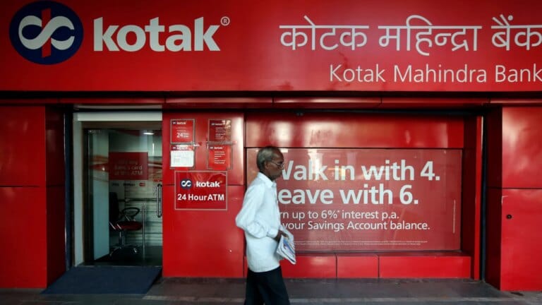 A person using a credit card for international shopping, representing kotak mahindra bank services.