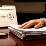 Professional reviewing tax documents on a laptop screen to represent gstat extends relaxed compliance