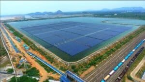 Solar panels at an NTPC Green Energy facility reflecting the sun