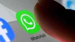 Several whatsapp users checking their phones for account status updates