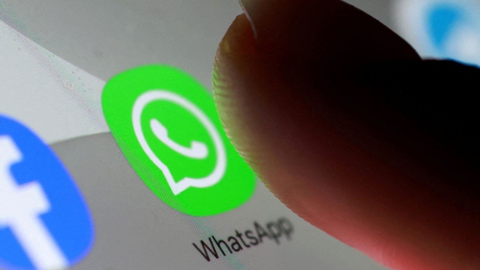 Several whatsapp users checking their phones for account status updates